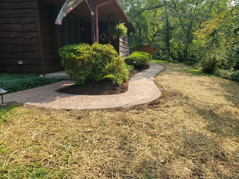 brick path winding around the side of a house