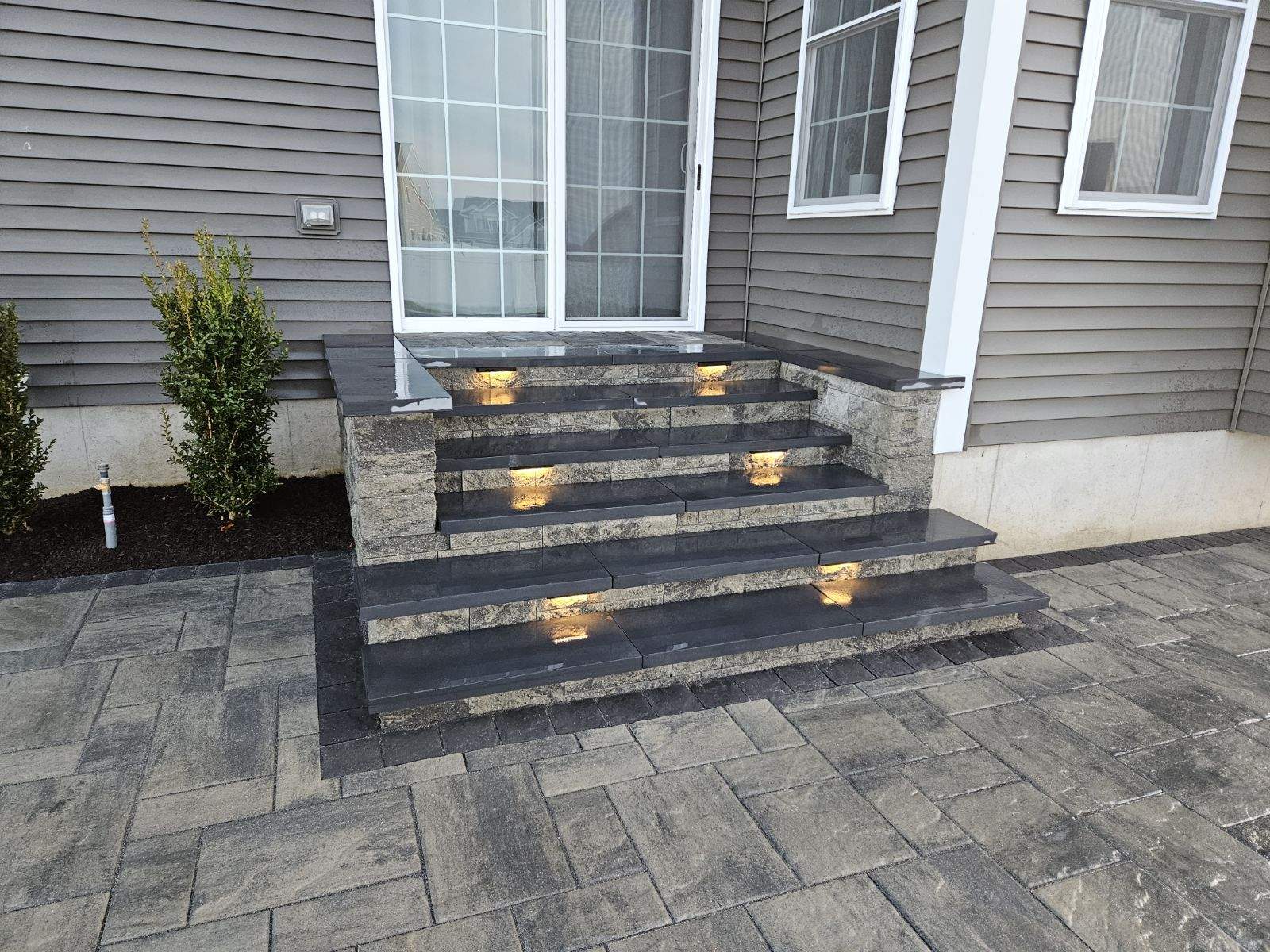 elegant steps with built in lighting leading up to the back door