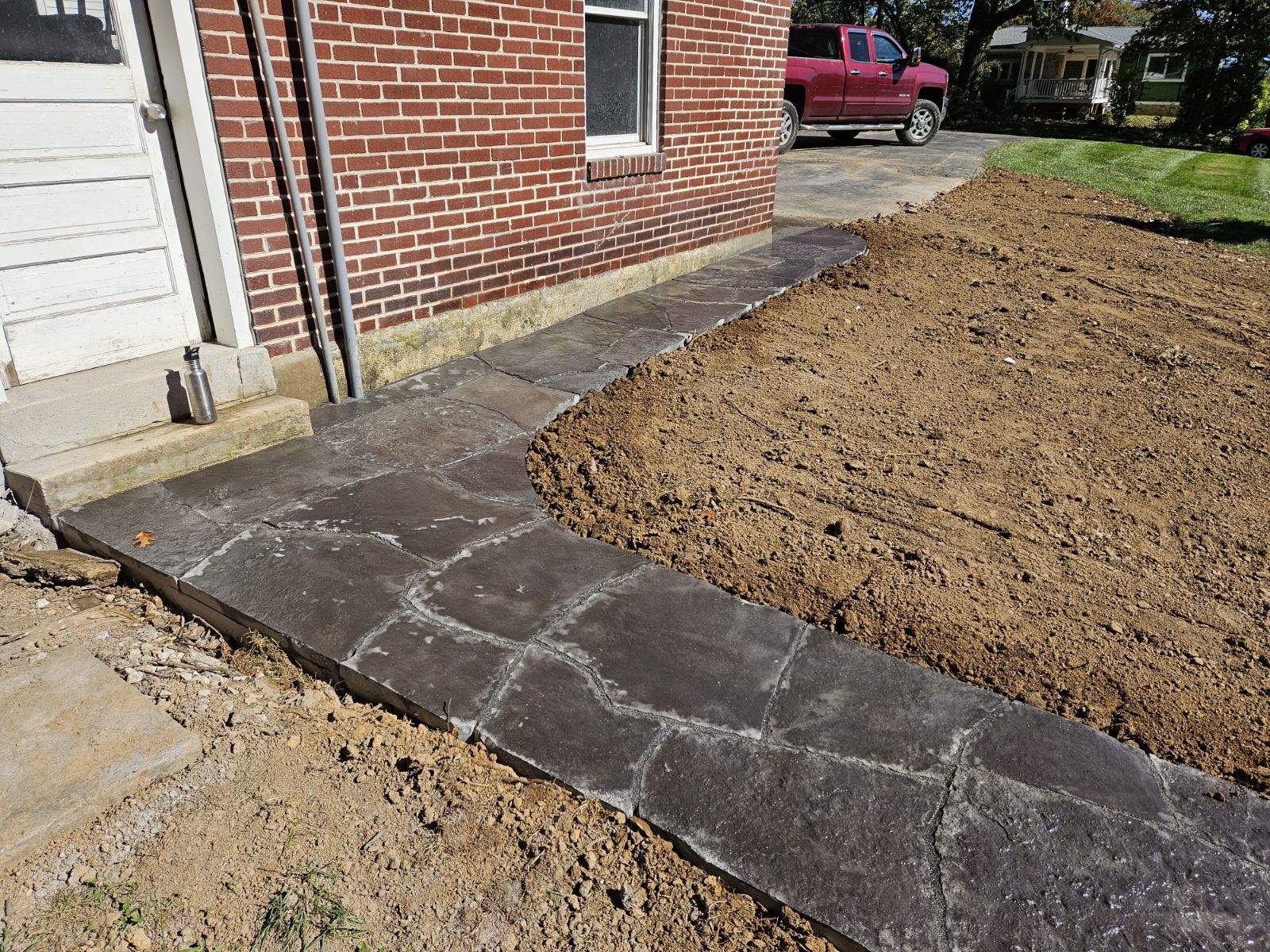 stone walkway matching patio connected to the shed and driveway