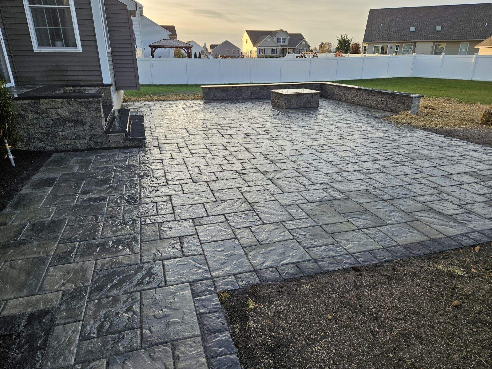 stone patio with alternating stone shapes and a square brick border