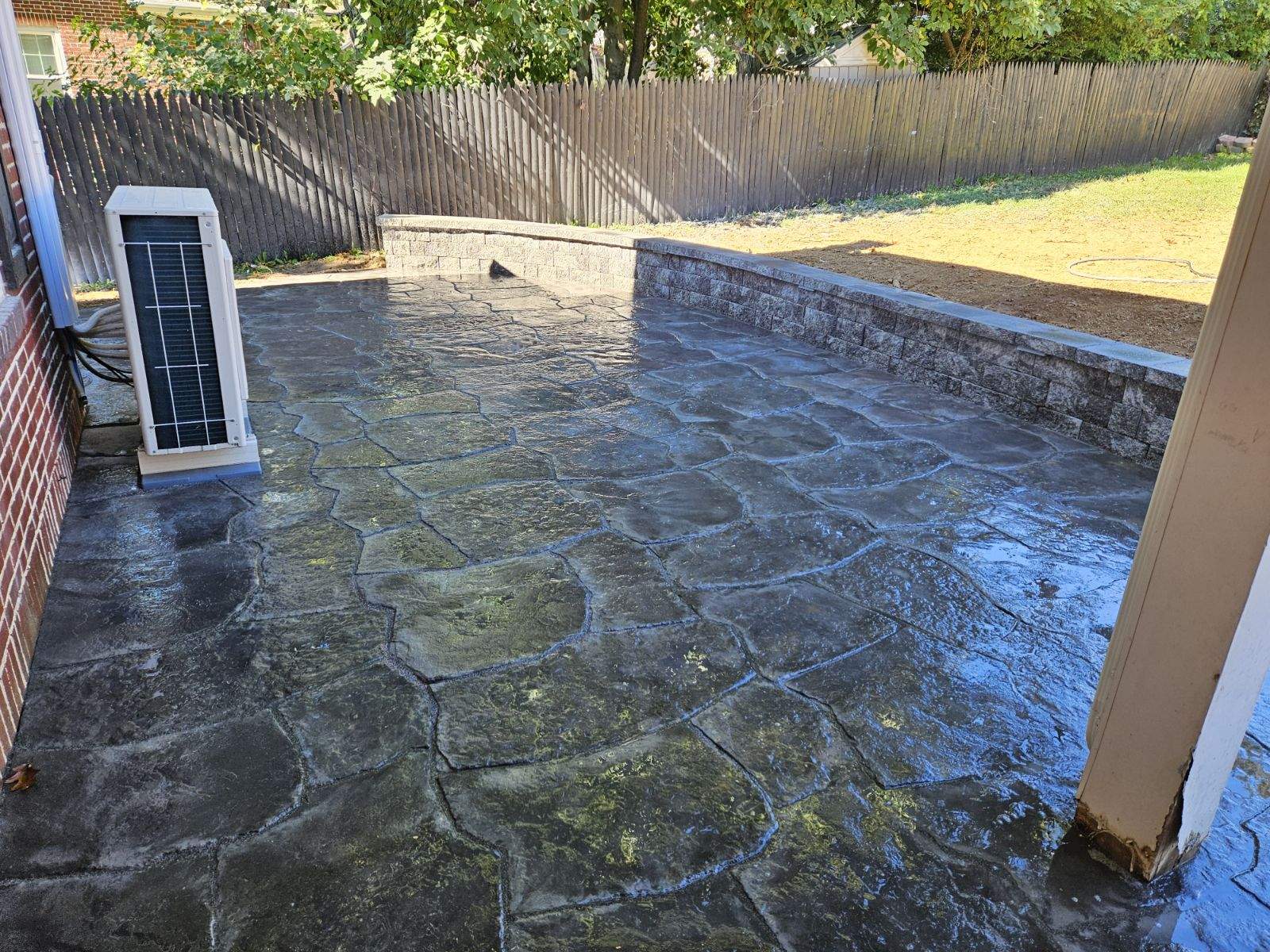 stone patio with retaining walls wrapping around the house