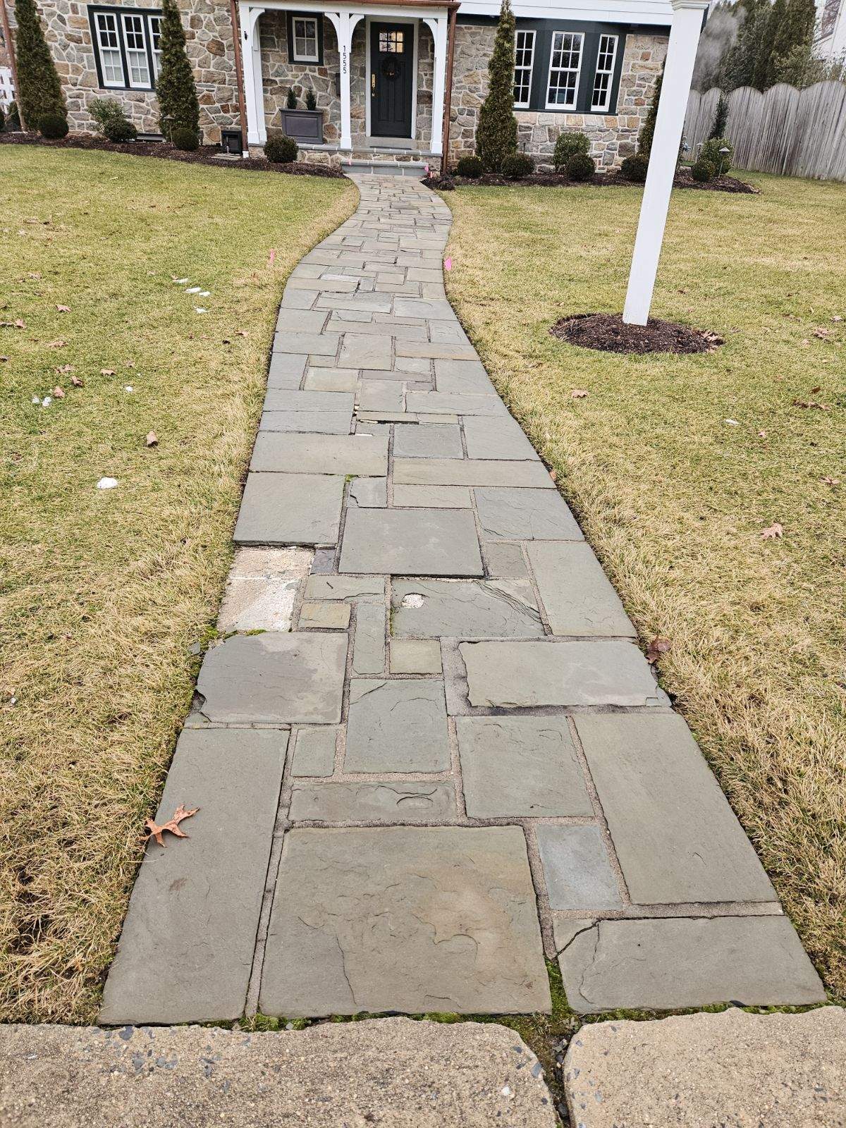 Before: stone walkway with varying sizes that's become very worn and irregular