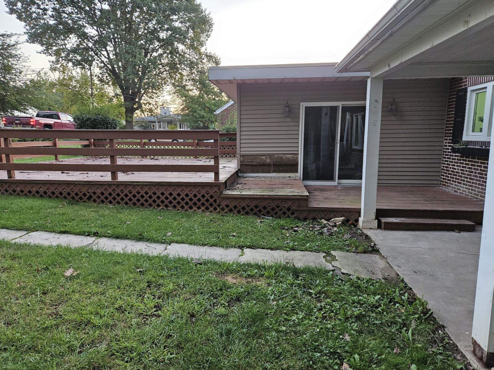 cement mini patio leading to wooden steps and deck