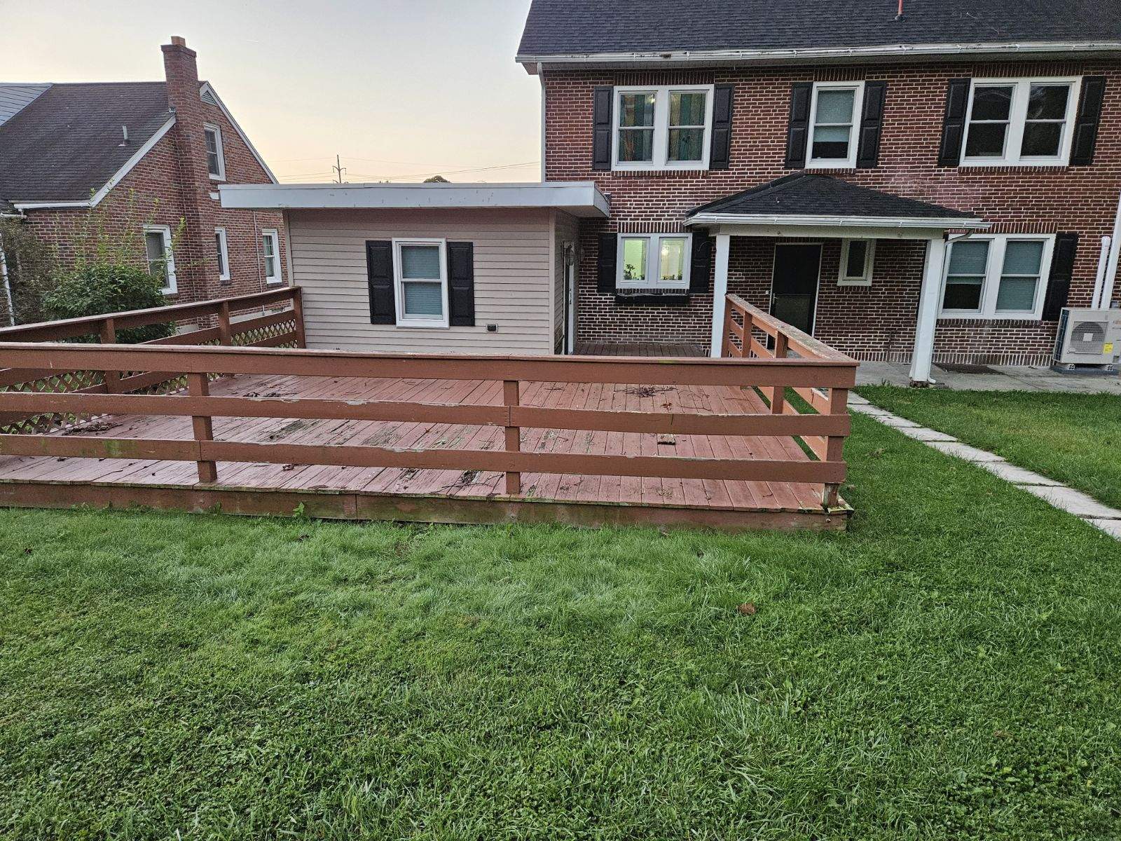 wooden deck connected to cement patio