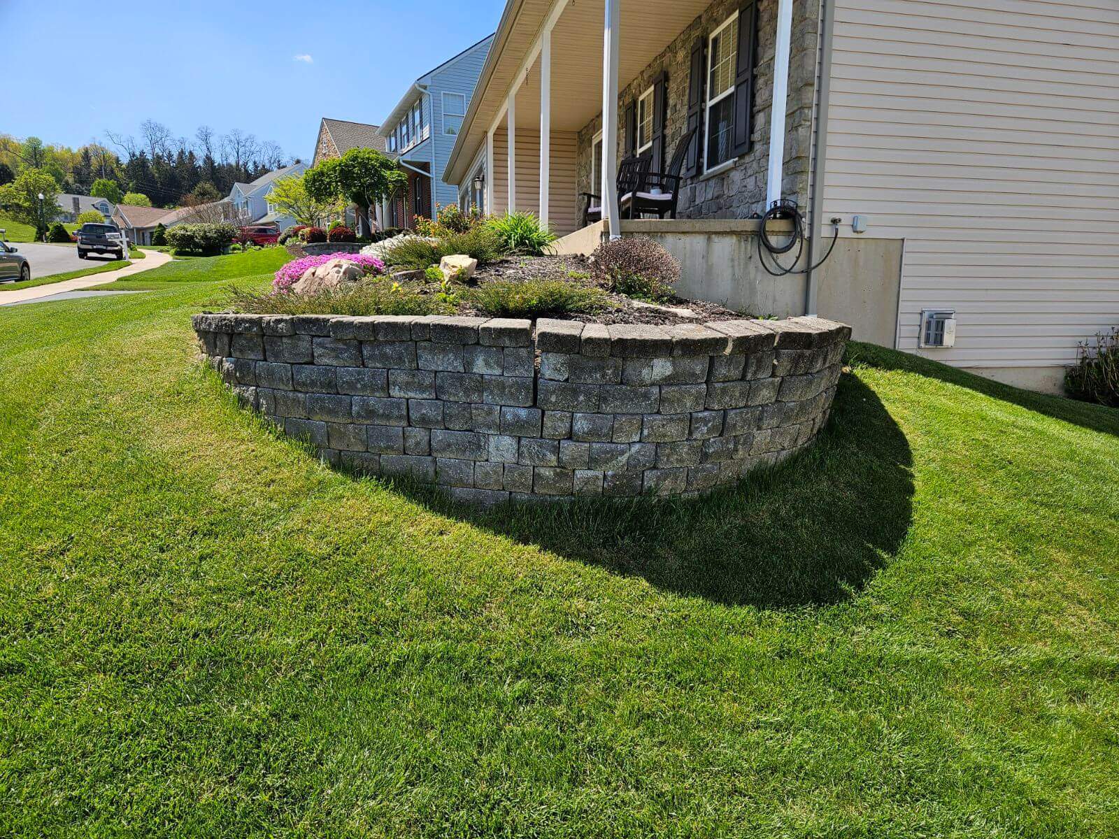 retaining wall falling apart at the corner of a house porch